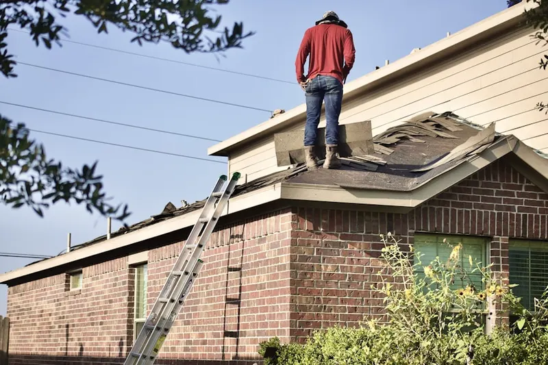 Professional roofer working on a residential roof in Leesville